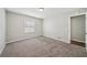 Bedroom featuring carpet, neutral walls, trim, and natural light from a window at 2466 Country Club Dr, Conyers, GA 30013