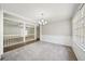 Bright dining room with carpet, modern chandelier, and views of the living area at 2466 Country Club Dr, Conyers, GA 30013