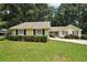 Inviting yellow home boasting manicured landscaping and an expansive green lawn at 2466 Country Club Dr, Conyers, GA 30013