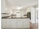 Kitchen with white cabinets, laminate flooring and black appliances at 2466 Country Club Dr, Conyers, GA 30013