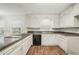 Open kitchen featuring white cabinets and dark countertops at 2466 Country Club Dr, Conyers, GA 30013