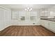 Bright eat-in kitchen area with laminate floors and white cabinets at 2466 Country Club Dr, Conyers, GA 30013