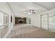 Bright, open living room with stone fireplace, neutral carpet, and sliding glass doors at 2466 Country Club Dr, Conyers, GA 30013