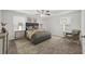 Beautifully staged main bedroom with carpet, a ceiling fan, two windows and warm neutral tones at 2466 Country Club Dr, Conyers, GA 30013