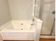 Bathroom with a soaking tub with tiled surround and a glass enclosed shower at 3884 Grovemont Pl, Duluth, GA 30096