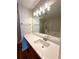Bathroom vanity with framed mirror, modern lighting, and a white countertop at 3884 Grovemont Pl, Duluth, GA 30096