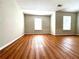 Sunlit bedroom featuring hardwood floors and a neutral wall color scheme at 3884 Grovemont Pl, Duluth, GA 30096