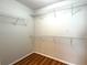 Walk-in closet with ample shelving and warm-toned wood floors at 3884 Grovemont Pl, Duluth, GA 30096