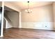 Dining room with wood floors, decorative wainscotting, and a hanging chandelier at 3884 Grovemont Pl, Duluth, GA 30096