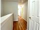 Hallway with wood floors leading to several bedrooms at 3884 Grovemont Pl, Duluth, GA 30096