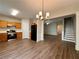 Open concept kitchen featuring stainless steel appliances and vinyl plank flooring at 3884 Grovemont Pl, Duluth, GA 30096