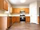 Kitchen with stainless steel appliances, wood cabinets and white countertops at 3884 Grovemont Pl, Duluth, GA 30096