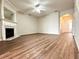 Bright living room featuring a fireplace, mantel, and vinyl plank flooring at 3884 Grovemont Pl, Duluth, GA 30096