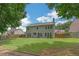 Spacious backyard features a large lawn, surrounded by a wooden fence, with mature trees, and patio area at 5077 Wellisford Ct, Suwanee, GA 30024