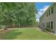 Spacious backyard with privacy fence, a patio area, and lush green grass at 5077 Wellisford Ct, Suwanee, GA 30024