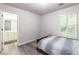Bedroom with wood-look flooring adjacent to bathroom at 5077 Wellisford Ct, Suwanee, GA 30024