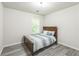 Bedroom with wood-look flooring and natural light at 5077 Wellisford Ct, Suwanee, GA 30024