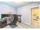 Bedroom used as home office with laundry room through the door at 5077 Wellisford Ct, Suwanee, GA 30024