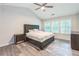 Bedroom with wood floors, windows, and a vaulted ceiling at 5077 Wellisford Ct, Suwanee, GA 30024