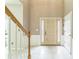 Light-filled foyer with tiled flooring, staircase with white railings, and a door with decorative sidelights at 5077 Wellisford Ct, Suwanee, GA 30024