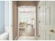 Hallway view through to the dining area boasting tile floors and abundant natural light at 5077 Wellisford Ct, Suwanee, GA 30024