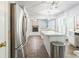 Kitchen featuring white cabinets, island with breakfast bar, and stainless appliances at 5077 Wellisford Ct, Suwanee, GA 30024