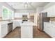 Modern kitchen with white cabinets, stainless steel appliances, and center island at 5077 Wellisford Ct, Suwanee, GA 30024