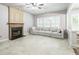 Living room featuring a fireplace, tile floors, and a comfortable couch at 5077 Wellisford Ct, Suwanee, GA 30024