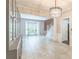 Bright, open living room with tile floors, elegant chandelier, and large windows at 5077 Wellisford Ct, Suwanee, GA 30024