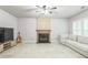 Open living room featuring a fireplace, tile floors, and a comfortable couch at 5077 Wellisford Ct, Suwanee, GA 30024