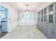 Bright living room with tile floors, built in cabinets, and a modern chandelier at 5077 Wellisford Ct, Suwanee, GA 30024
