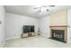 Living room with fireplace, TV, guitar, and tile floors at 5077 Wellisford Ct, Suwanee, GA 30024