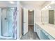 Bathroom featuring a walk-in shower and vanity with wood-look flooring at 5077 Wellisford Ct, Suwanee, GA 30024