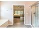 Bright main bathroom with tub and shower, featuring wood-look floors at 5077 Wellisford Ct, Suwanee, GA 30024