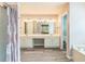 Bright bathroom with double vanity and wood-look flooring at 5077 Wellisford Ct, Suwanee, GA 30024