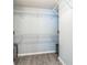 Spacious walk-in closet with wire shelving and wood-look flooring at 5077 Wellisford Ct, Suwanee, GA 30024