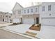 View of newly constructed townhomes featuring brick and painted exteriors with sidewalks at 697 Sunstone Ln, Lawrenceville, GA 30043
