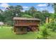 Large backyard featuring an upper wooden deck and lush green grass at 115 Elizabeth Way, Ellenwood, GA 30294