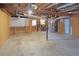 Unfinished basement with workbench and open ceiling at 115 Elizabeth Way, Ellenwood, GA 30294