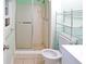 Bathroom with shower featuring white tiling and shelving unit at 115 Elizabeth Way, Ellenwood, GA 30294