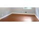 Bedroom featuring hardwood floors and painted with a neutral paint color and a window at 115 Elizabeth Way, Ellenwood, GA 30294