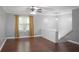 Bright living room featuring hardwood floors, neutral walls, a ceiling fan, and a staircase at 115 Elizabeth Way, Ellenwood, GA 30294