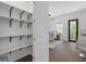 Walk-in pantry featuring white shelves and ample storage space with dining area at 161 Brush Creek Ct, Stockbridge, GA 30281