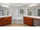 Bathroom with double vanities, soaking tub, and neutral finishes offers a serene retreat at 2040 Village Green Dr, Fairburn, GA 30213