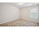 Light-filled bedroom featuring a window, neutral walls, and carpet for a comfortable feel at 2040 Village Green Dr, Fairburn, GA 30213