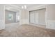 Inviting dining room with wainscoting, chandelier, neutral carpet and paint, plus easy access to other rooms at 2040 Village Green Dr, Fairburn, GA 30213