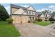 Charming two-story home with a two-car garage and driveway, showcasing its inviting curb appeal at 2040 Village Green Dr, Fairburn, GA 30213