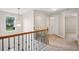 Hallway with light fixture, window, and doors leading to various rooms at 2040 Village Green Dr, Fairburn, GA 30213