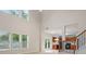 A spacious living room with bright windows that provide an abundance of natural light, wood-look flooring and kitchen views at 2040 Village Green Dr, Fairburn, GA 30213