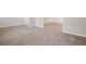 Bright, spacious living area featuring neutral paint, carpet and multiple doorways offering easy access at 2040 Village Green Dr, Fairburn, GA 30213